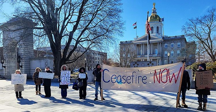 A group of people holding a banner [Description automatically generated]